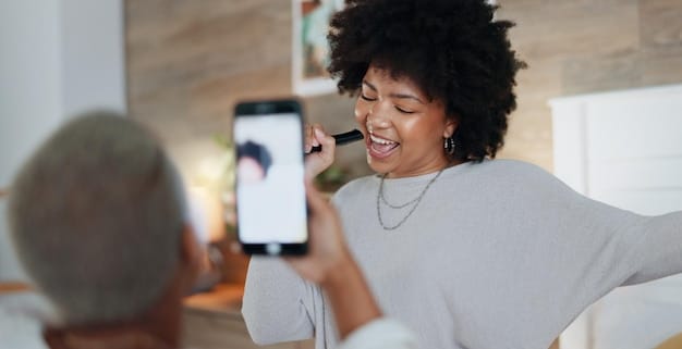 A person holding a phone displaying a podcast episode with positive comments and ratings, highlighting audience engagement and feedback.
