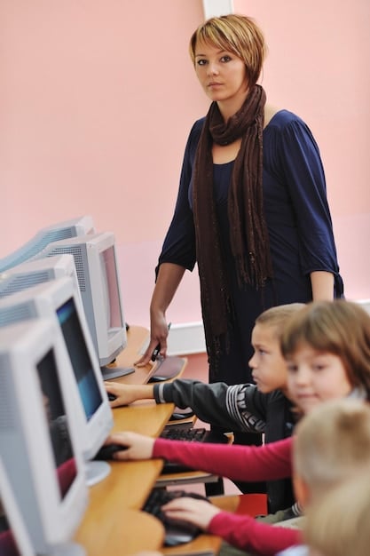 A teacher guiding students through a media literacy lesson, using various media formats to analyze and evaluate the credibility of sources, highlighting the active role of education in shaping informed citizens.