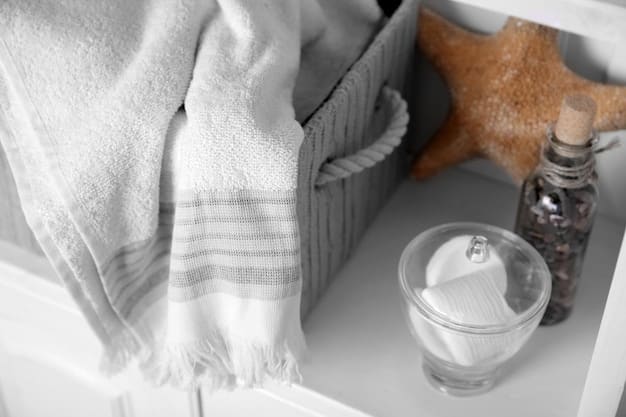 Close-up shot of a stack of folded white linen towels in a bathroom, next to a woven basket filled with lavender soaps. The background features a white subway tile wall and a glimpse of a clawfoot bathtub. The lighting is soft and natural.