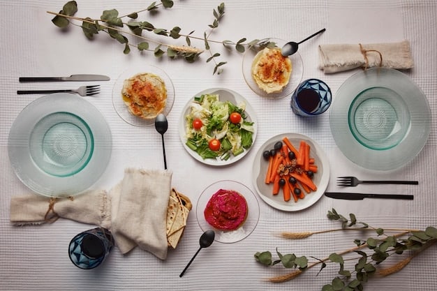 Overhead shot of a dining table set for a casual lunch. The table is covered with a white linen tablecloth and features blue and white porcelain plates, silverware, and linen napkins. A ceramic pitcher filled with lemonade and sliced lemons sits in the center of the table.