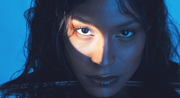A close-up of an AI influencer's eyes, showcasing the slightly unnatural lighting and lack of subtle imperfections that would be present in a real person's eyes.